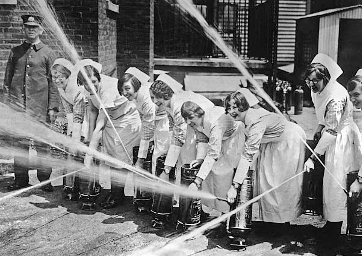 Nurses
Nurses at St Barnabas Hospital in Newark, New Jersey, practice their fire drill under the supervision of James A Cullimore of the Newark Fire Department, circa 1925. Left to right: E.L. Bloom, Ellen Jones, Helen O'Neill, Artjeral Donovan, Elizabeth Wilson, Gunhild Anderson, Alice McKay and Florence Amber. 
Photo by Henry Miller News
